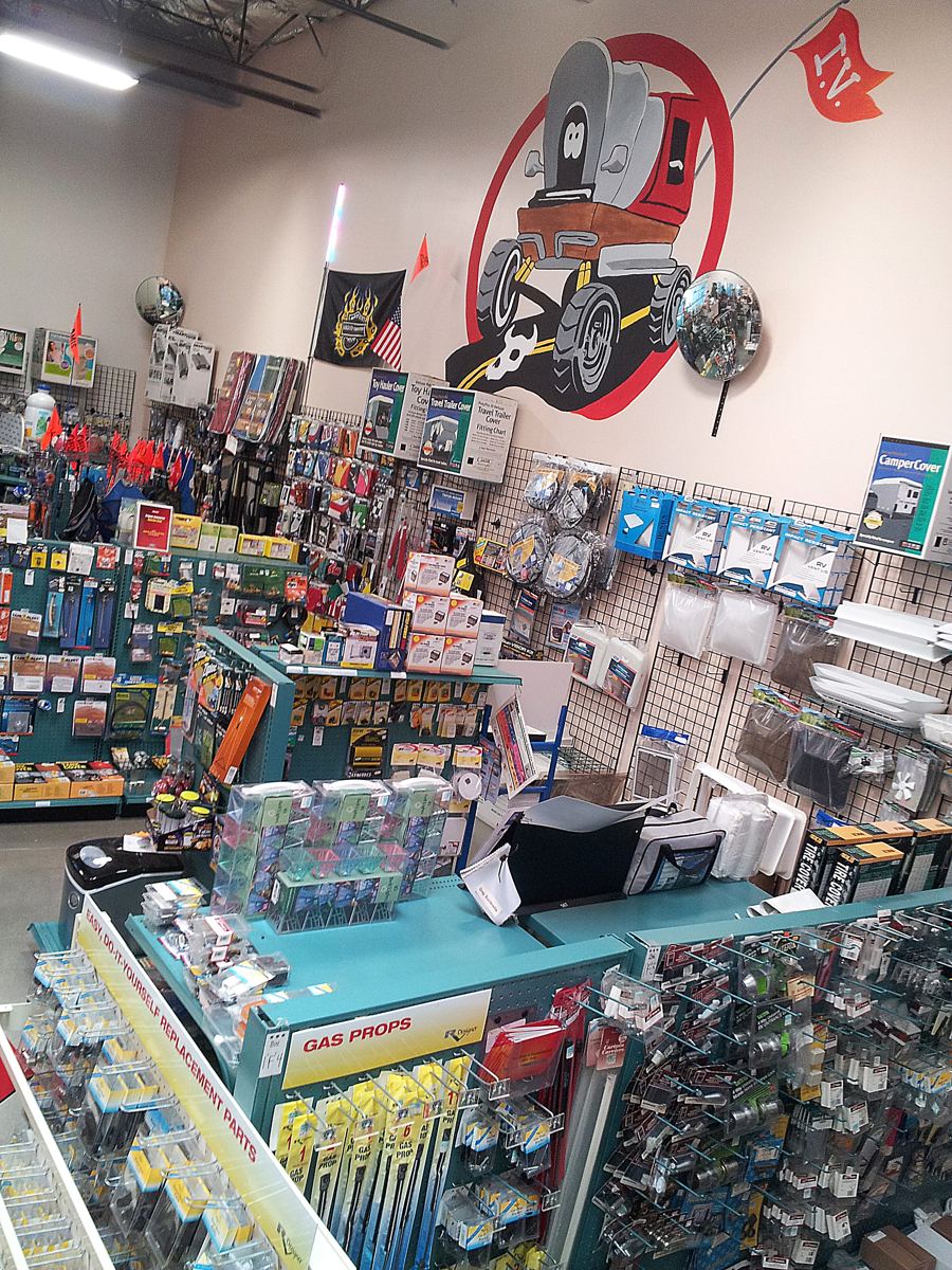 Inland Valley RV supply store interior with parts wall and shop mascot mural
